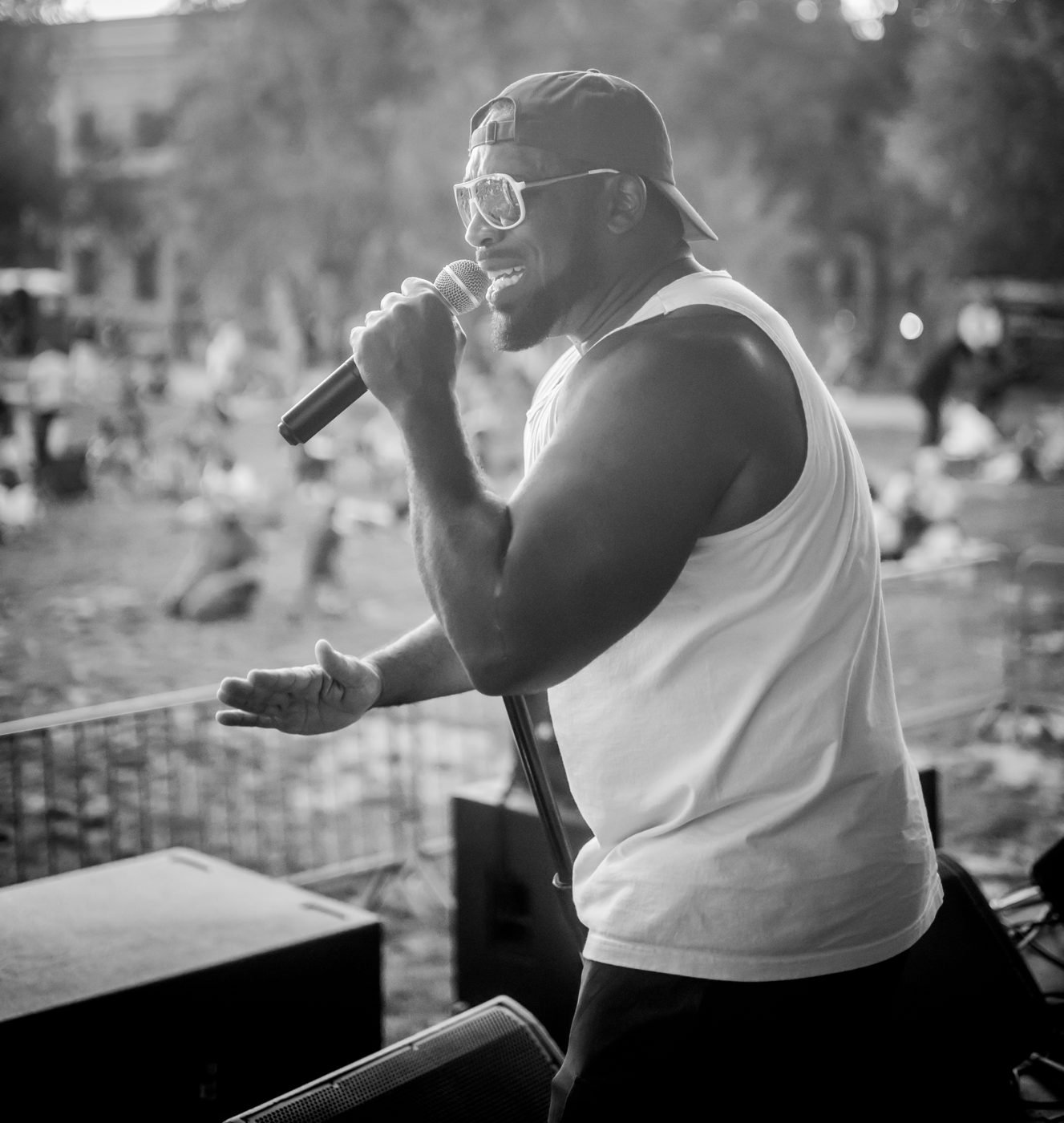 Bad Juju performing outdoors with a microphone